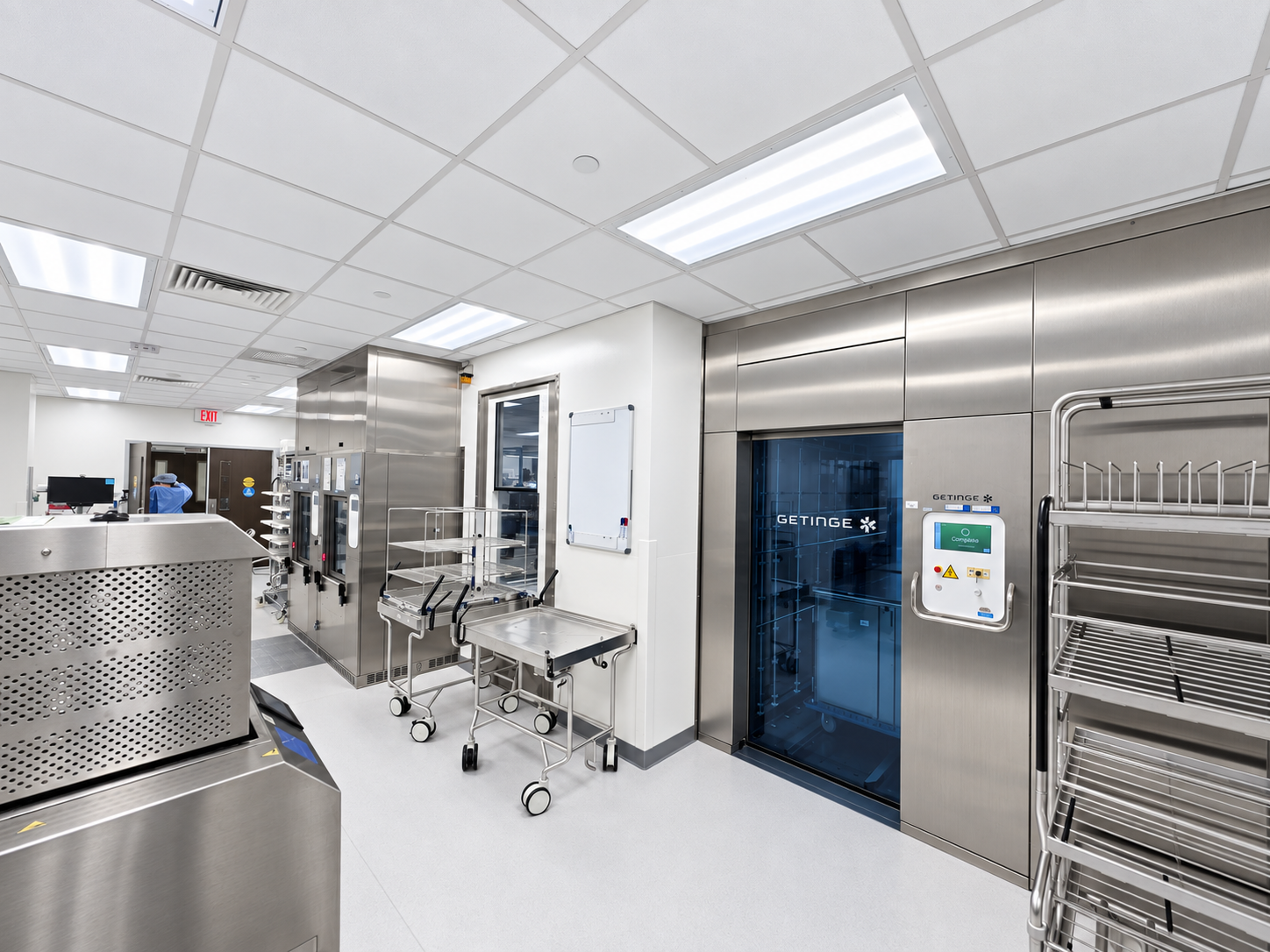 Sterile processing department with washer-disinfectors and loading carts