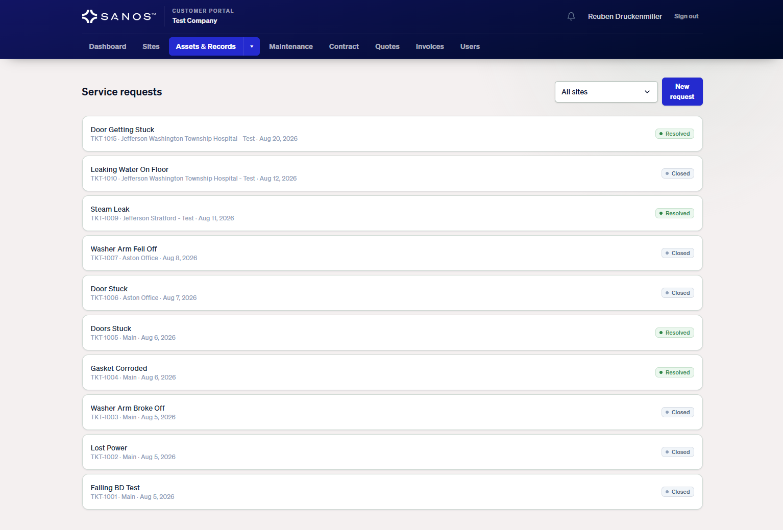 Sanos customer portal showing service requests with ticket numbers, sites, and current statuses